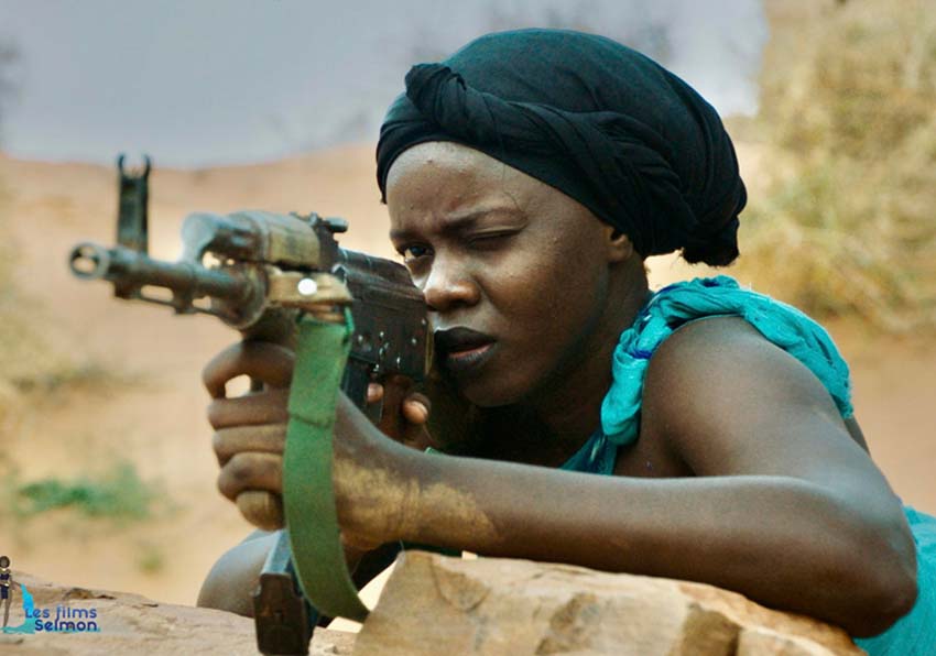 A woman aiming a rifle